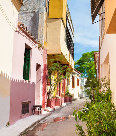 Narrow alley with colourful neoclassical houses in Plaka, one of the most iconic sights near Athenian Callirhoe
